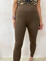 model wears brown lycra leather legging  styled with lycra leopard bodysuit 