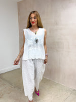 model wearing floral Embroidered sleeveless Vest Top In White styled with Broderie Anglaise Balloon Trousers In White