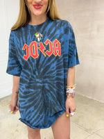 Model wearing a tie dye oversized graphic t-shirt featuring a AC/DC band logo