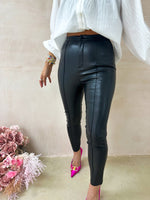 model wearing High Waisted Leather Look button front skinny Trousers In Black styled with balloon sleeve button front white blouse 