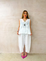 model wearing floral Embroidered sleeveless Vest Top In White styled with Broderie Anglaise Balloon Trousers In White