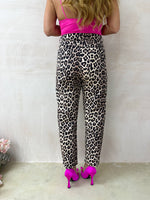 model wearing High Waisted button front Jeans In Leopard Print styled with lycra pink bodysuit 