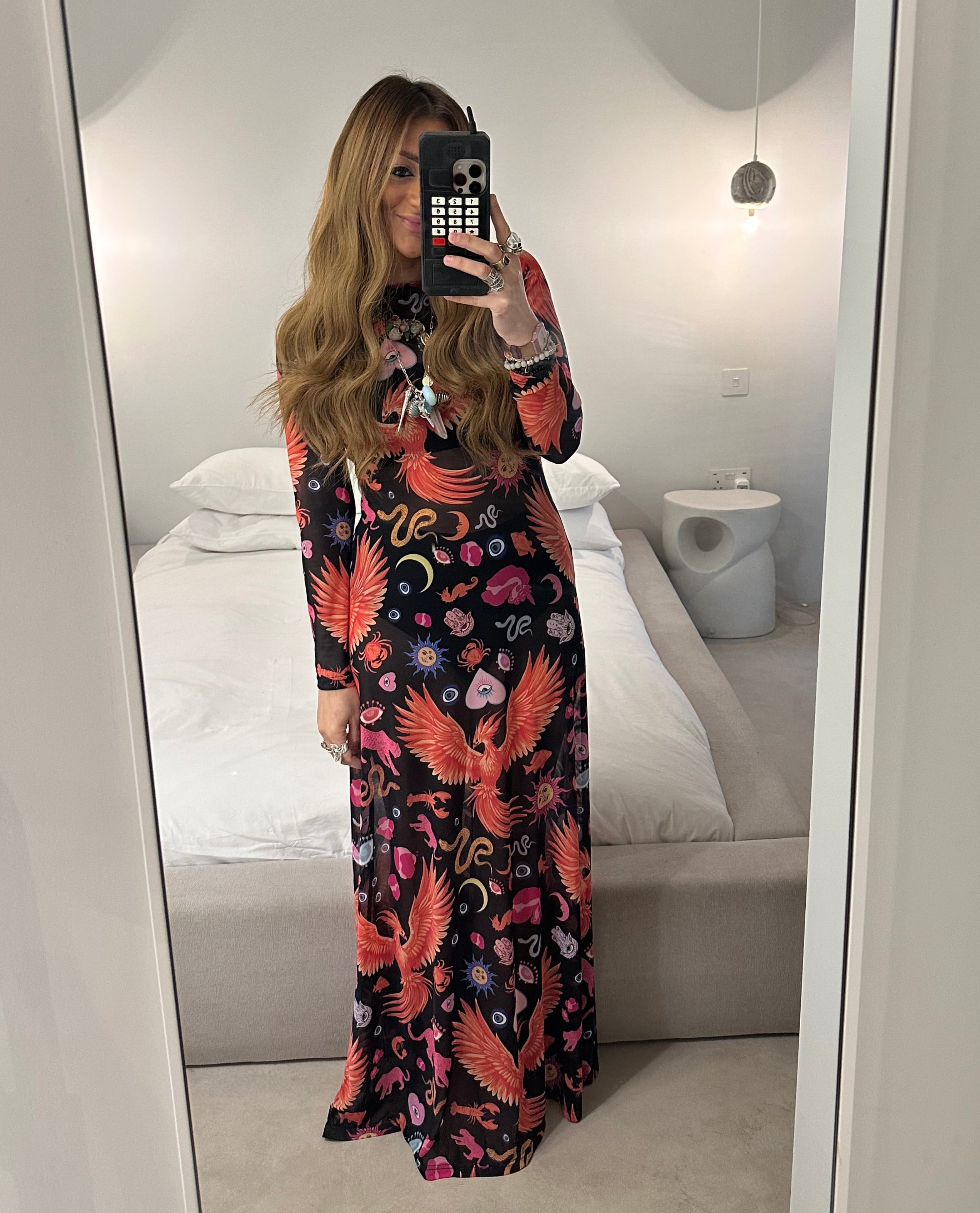 Person wearing a floral dress in front of a mirror