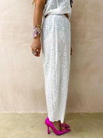 close up of model wearing Broderie Anglaise Balloon Trousers In White style with matching top 