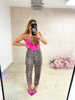 mirror selfie of model wearing hot pink lycra bodysuit with scoop neckline and thin straps styled with leopard print jeans