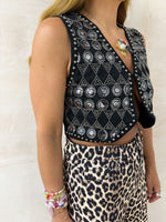 side  close up of model wearing Embellished Sequin Waistcoat In Black styled with leopard print tappered jeans