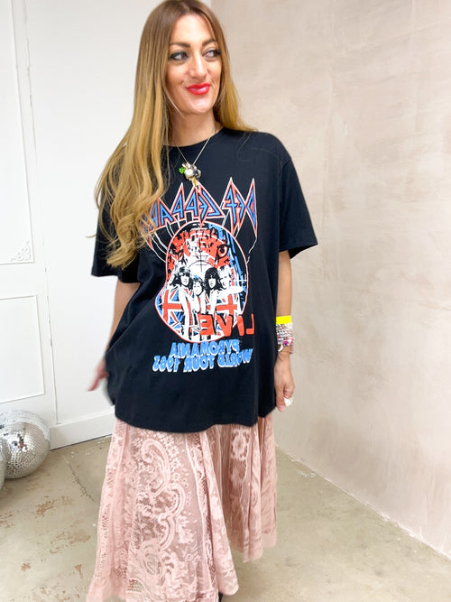 model wearing oversized graphic t-shirt with Def Leppard 'Pyro World Tour' graphic styled with floaty midi sheer lace skirt 