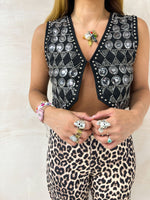 close up of model wearing Embellished Sequin Waistcoat In Black styled with leopard print tappered jeans