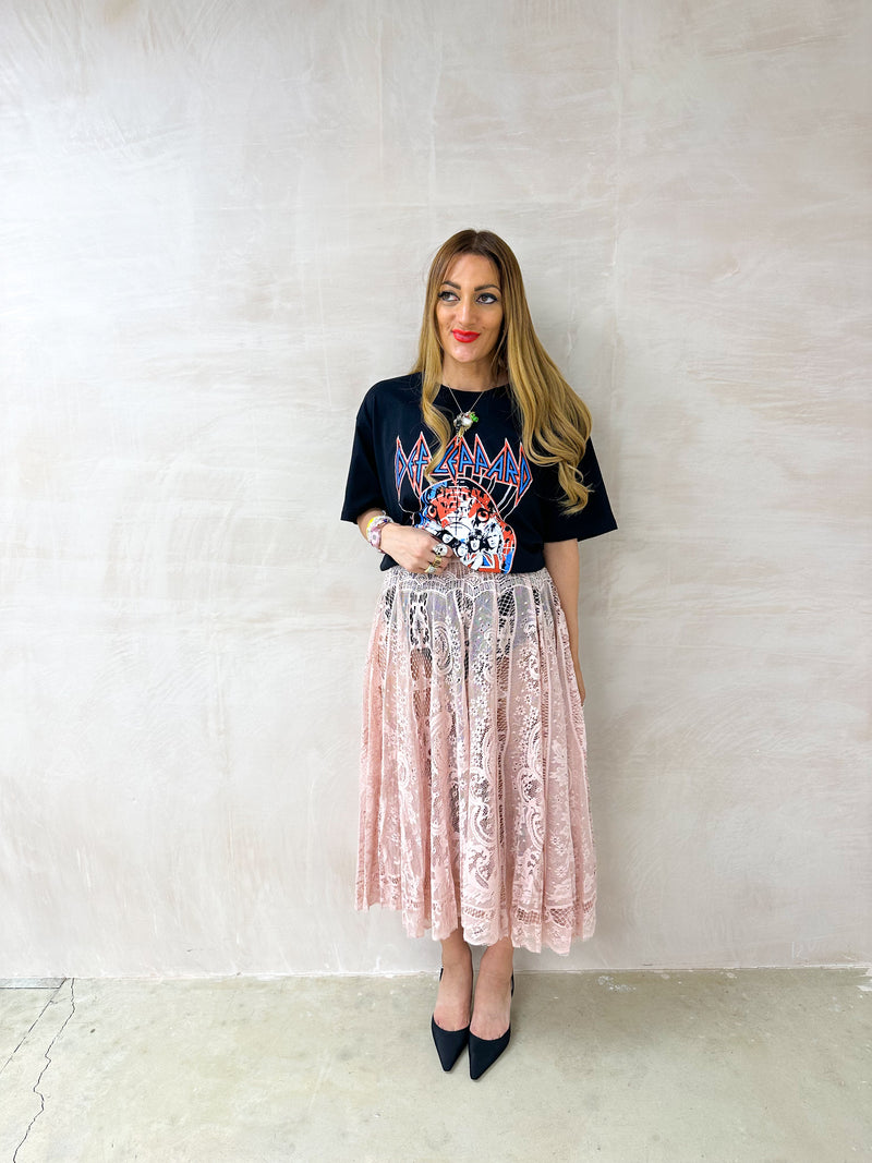 model wearing oversized graphic t-shirt with Def Leppard 'Pyro World Tour' graphic styled with floaty midi sheer lace skirt 