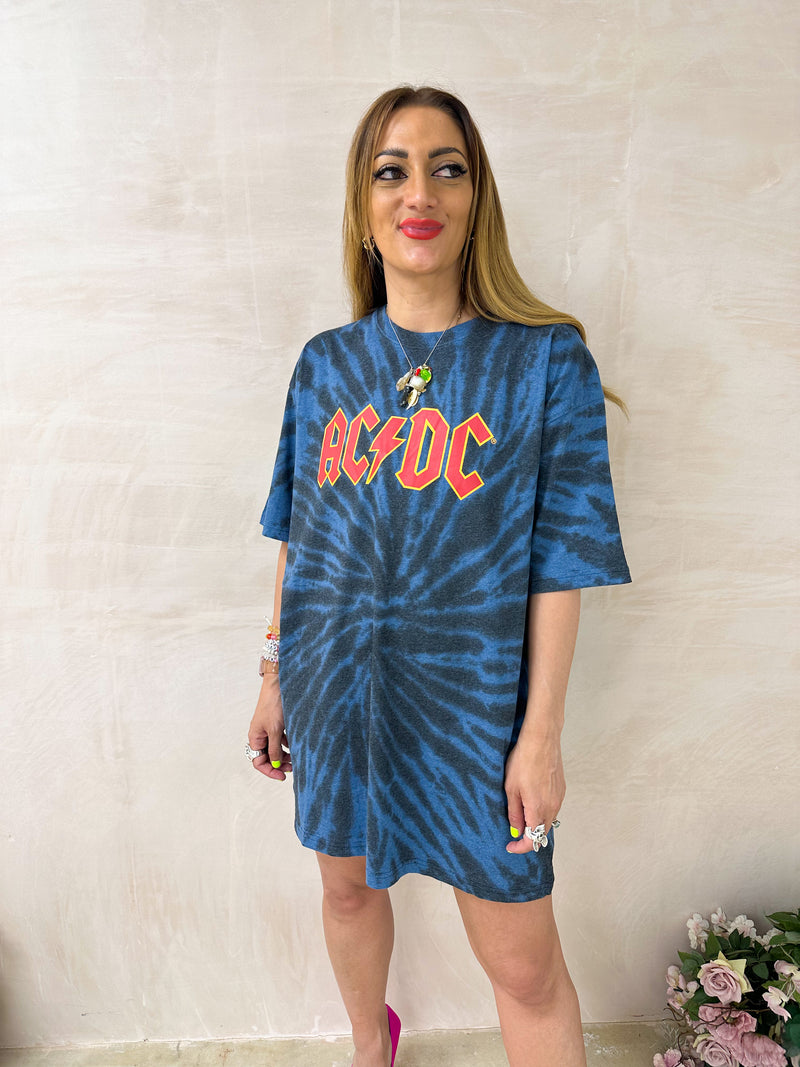 Model wearing a tie dye oversized graphic t-shirt featuring a AC/DC band logo