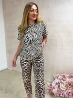 model wearing High Waisted button front Jeans In Leopard Print styled with oversized leopard print t-shirt 