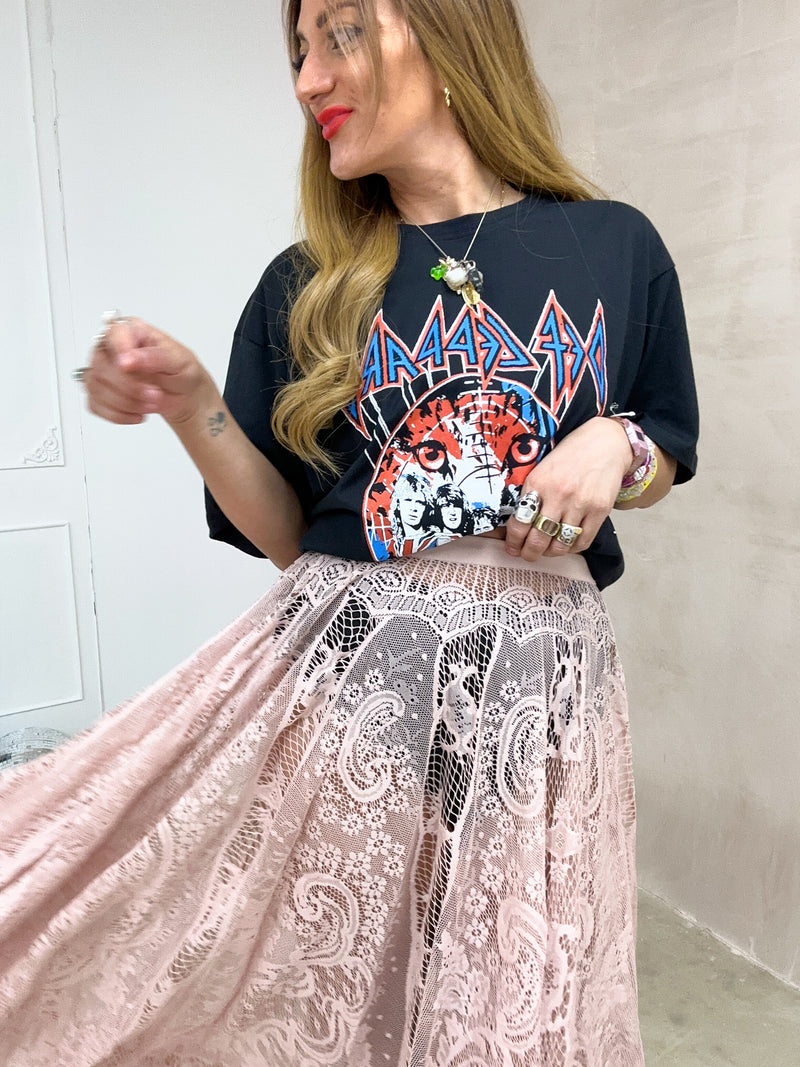 close up of model wearing oversized graphic t-shirt with Def Leppard 'Pyro World Tour' graphic styled with floaty midi sheer lace skirt 